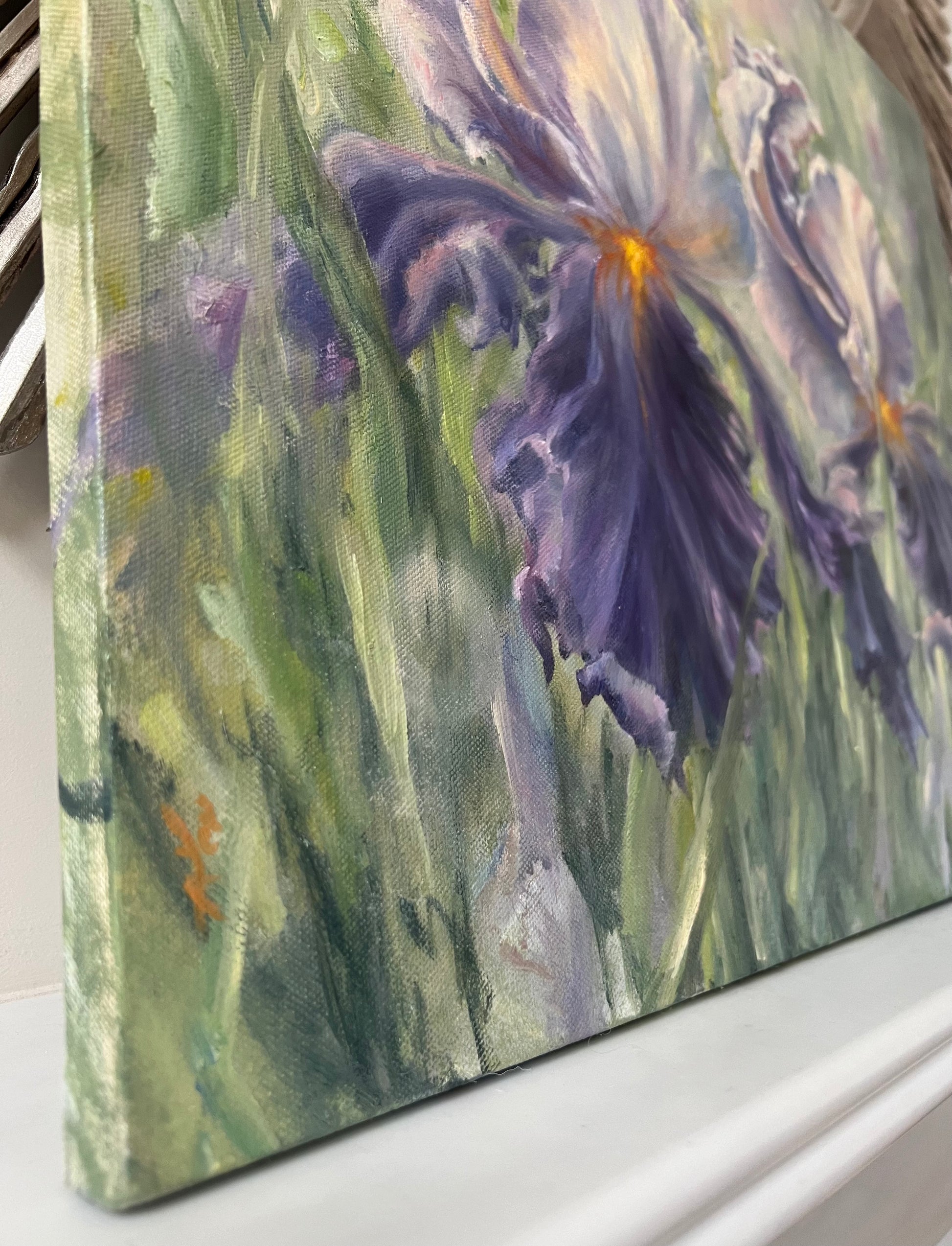 Close up of a floral painting, showing green grass and leafs.