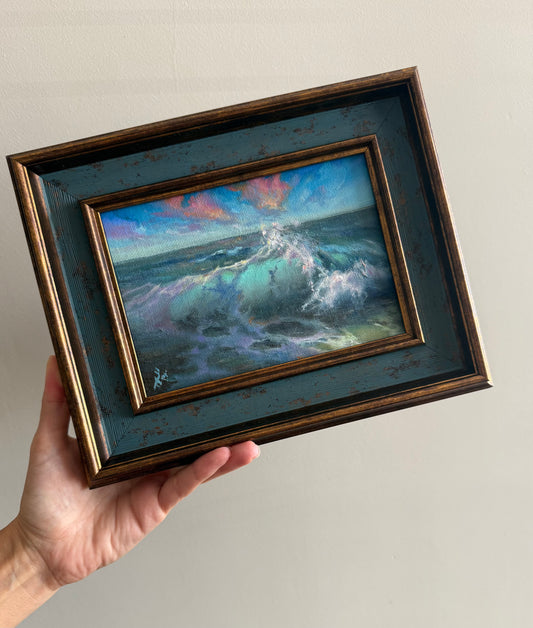Miniature ocean painting, bright colours, clouds above the sea, framed.