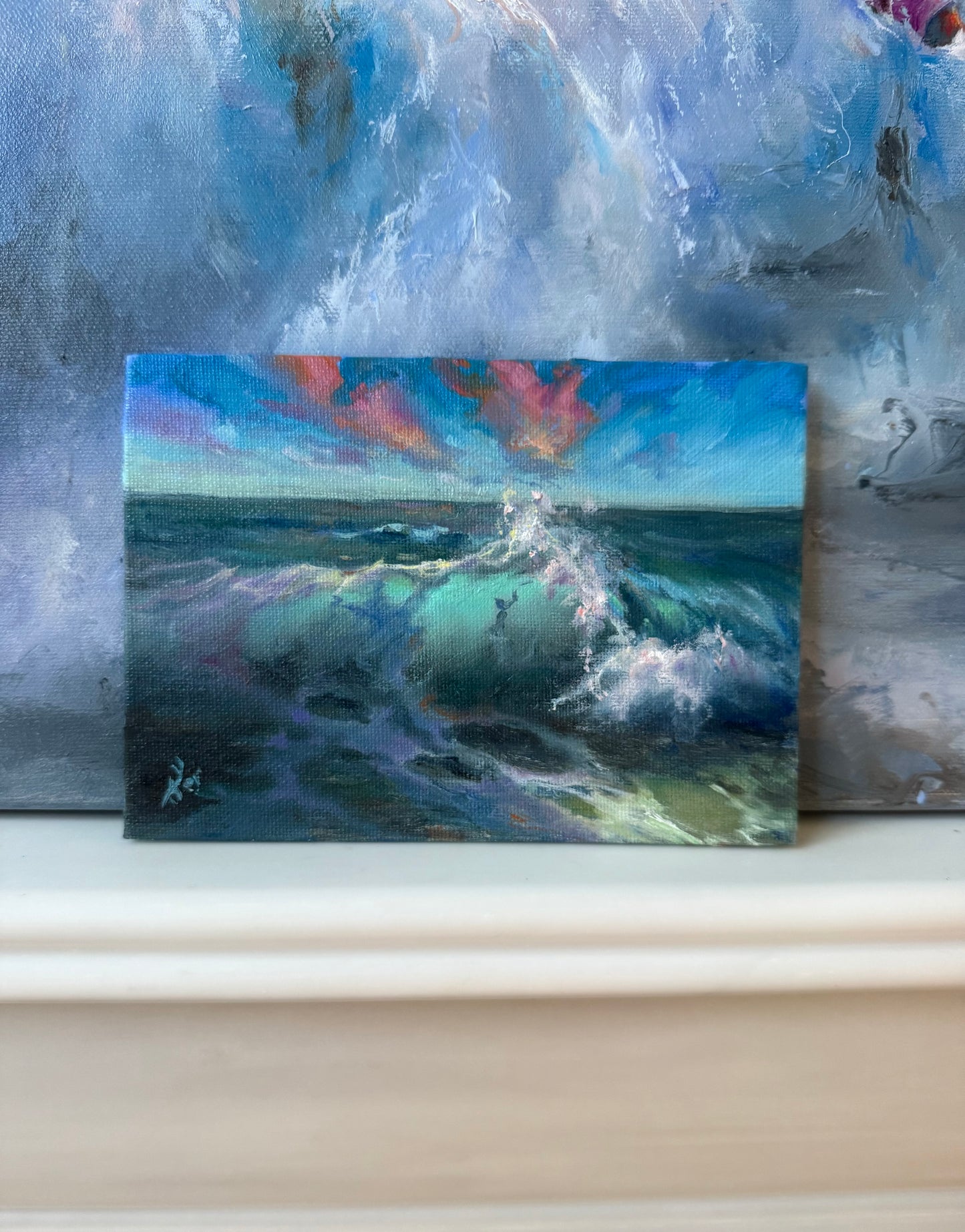 Small seascape, featuring sunset clouds and crashing waves.