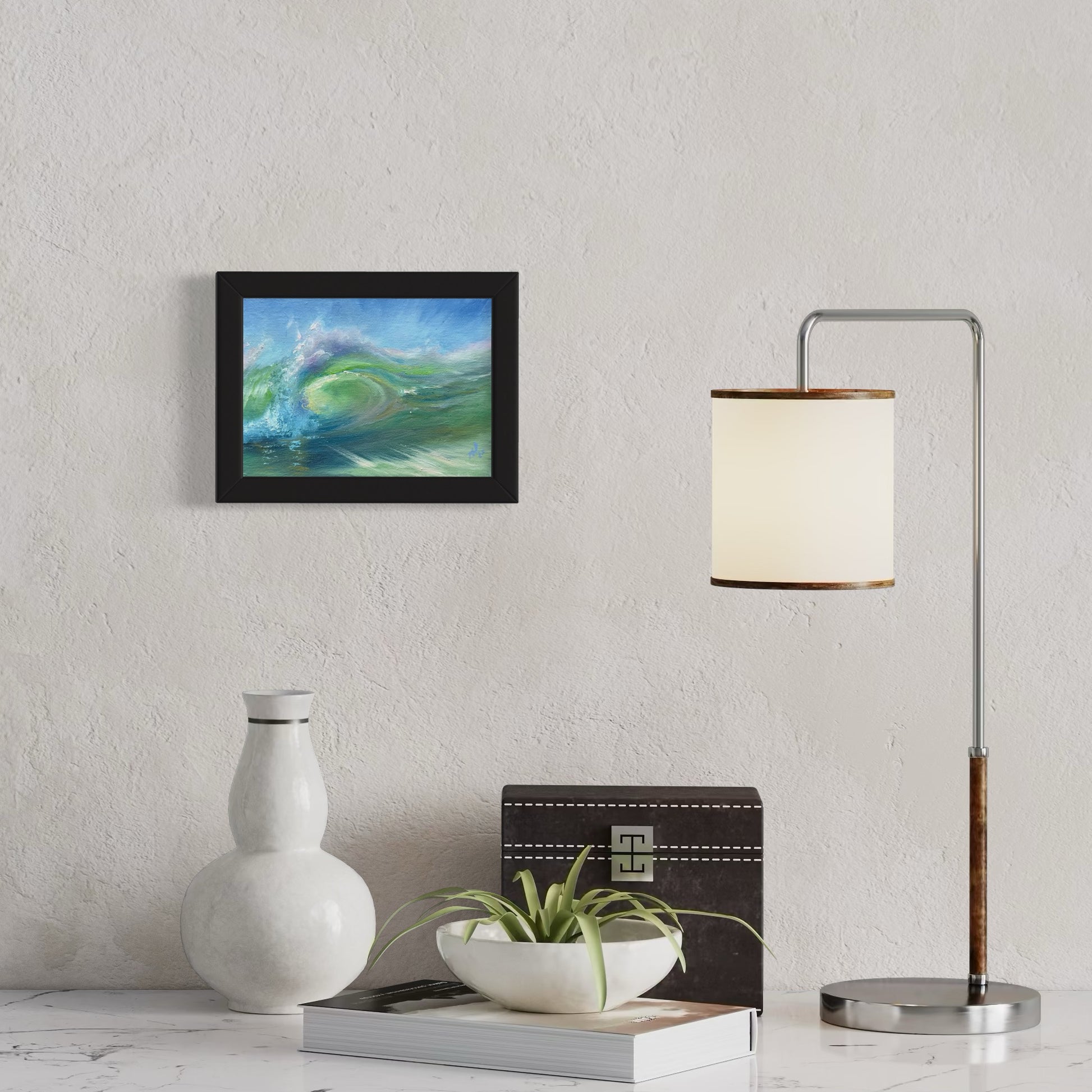 Small marine painting , framed in black, hanging on the wall.