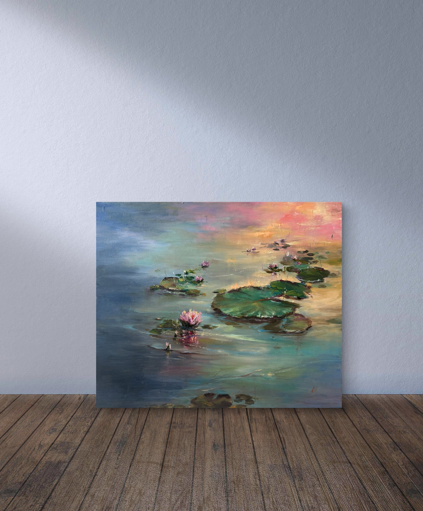 Painting of a water lily pond on a wooden floor with a gray wall background