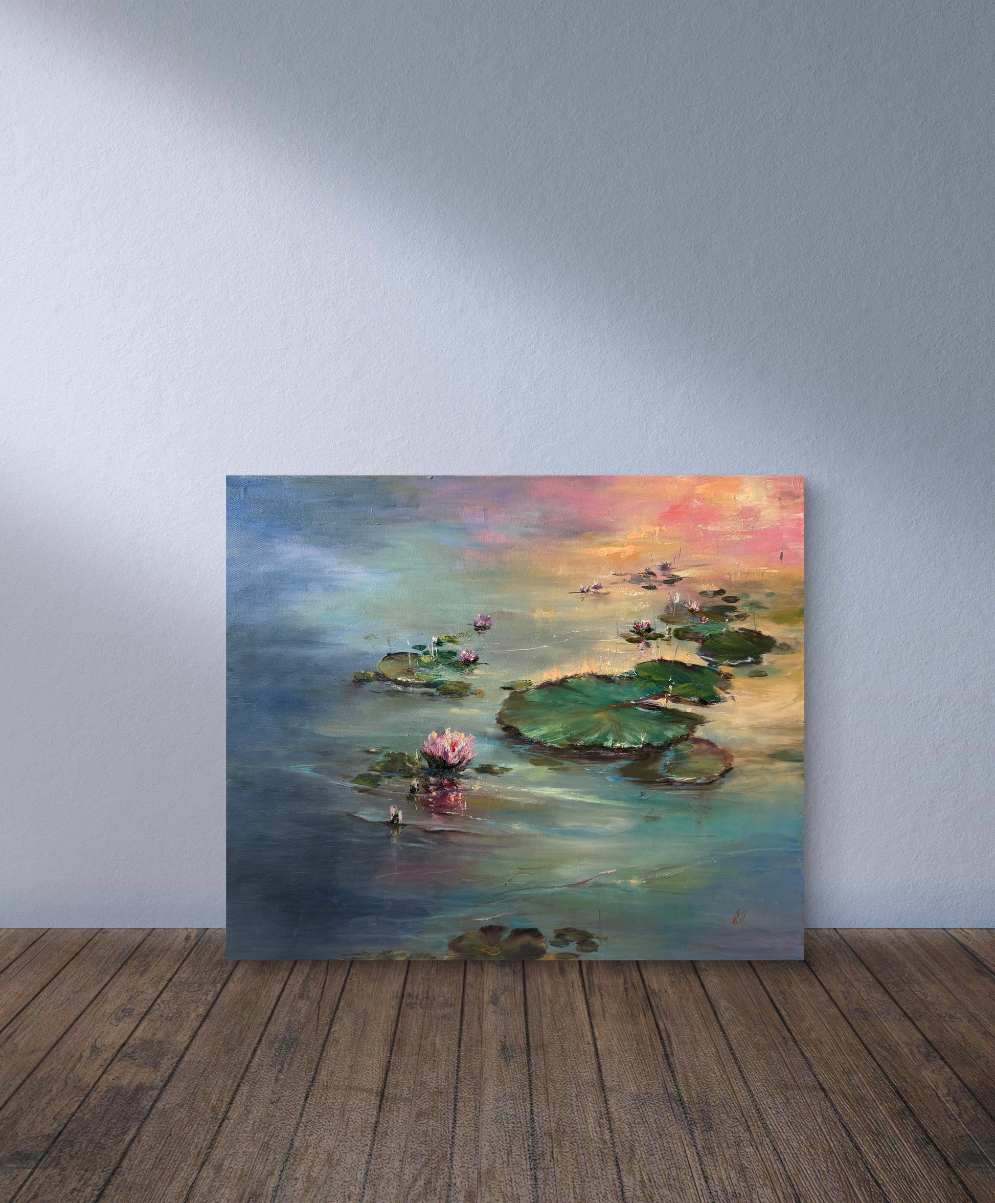 Painting of a water lily pond on a wooden floor with a gray wall background
