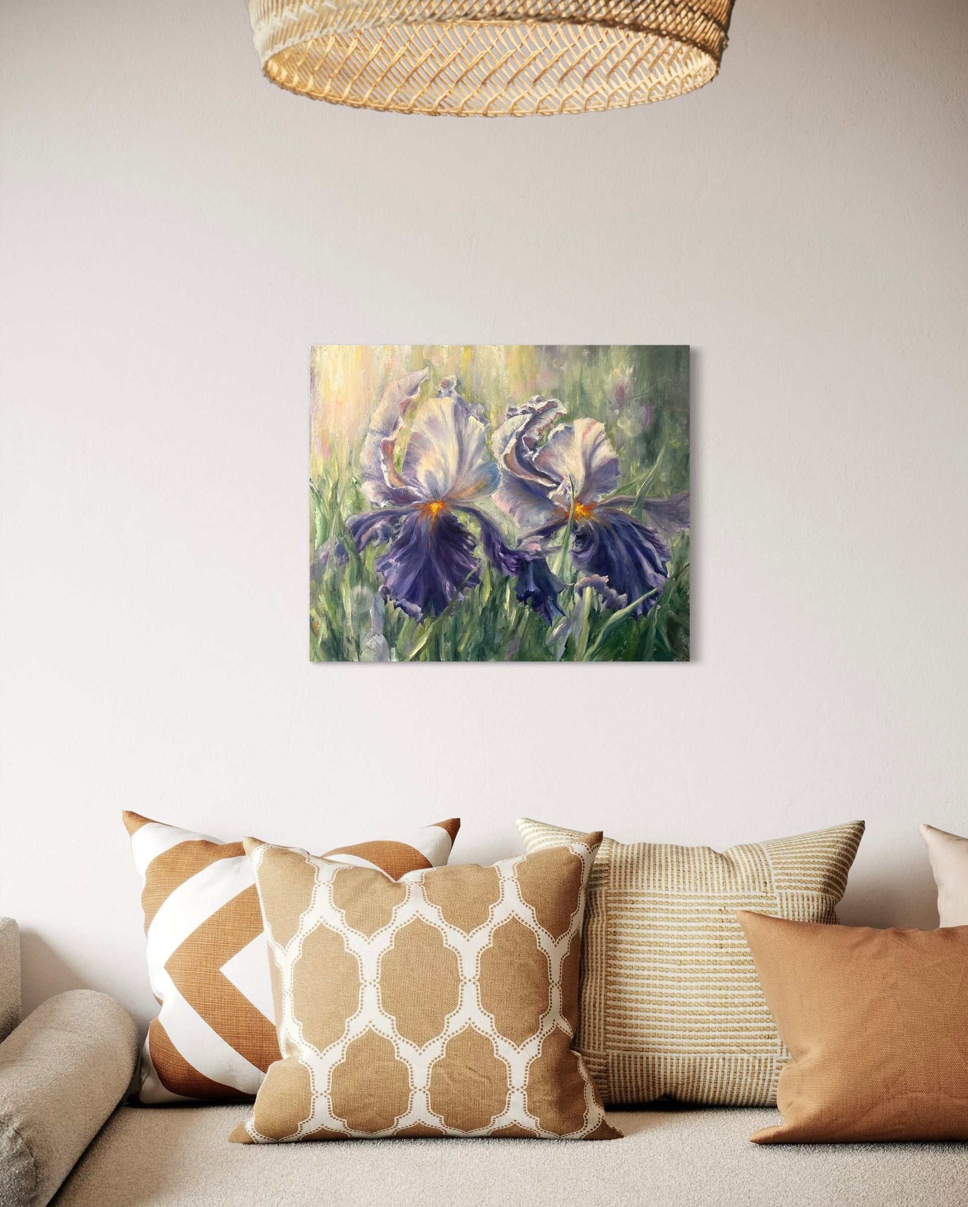 Floral painting of large white and purple flowers hanging above the sofa.