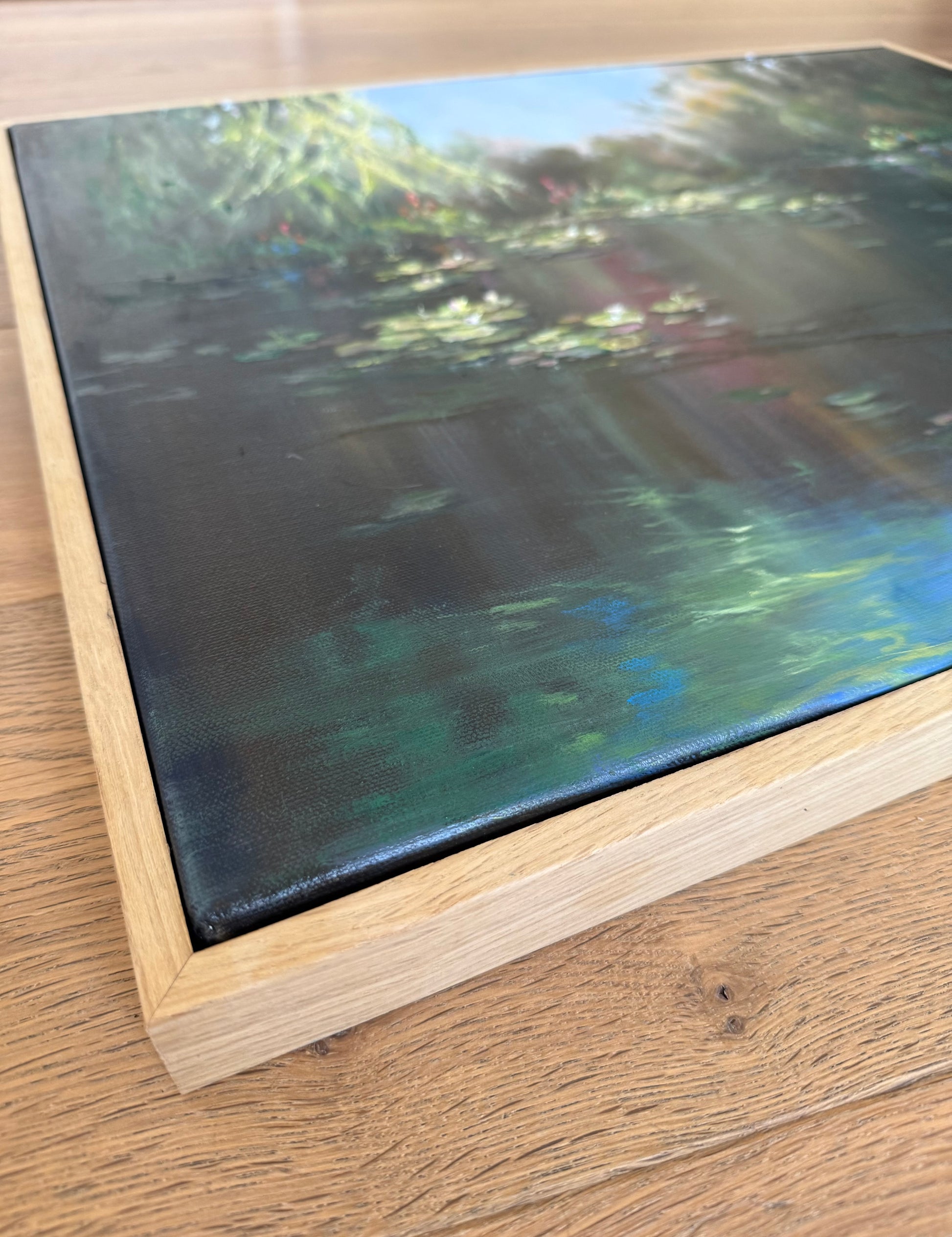 Lily pond oil painting in oak veneer frame.