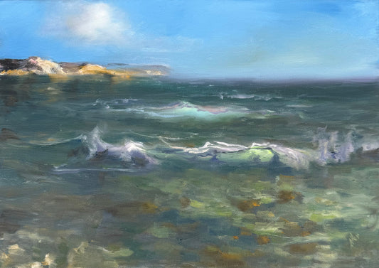 Green seascape featuring distant cliffs, turquoise glowing wave in the middle and clear green tidal waters in foreground.