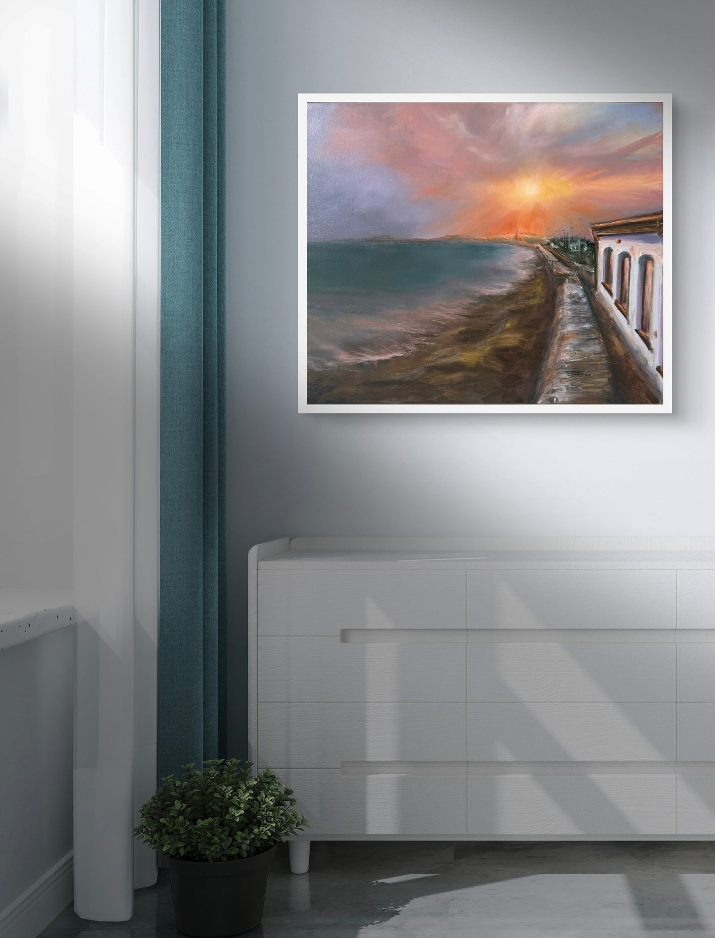 Framed artwork of a sunset over sea water in a modern interior setting.