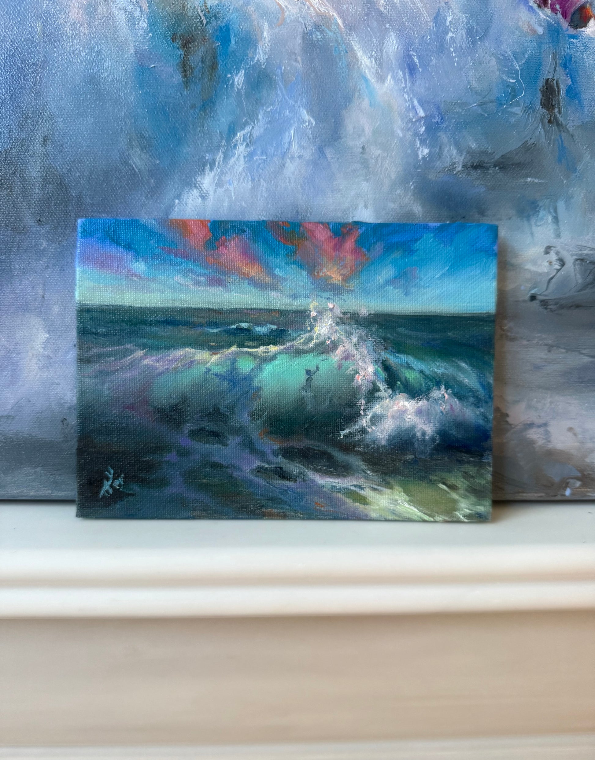 Small seascape, featuring sunset clouds and crashing waves.