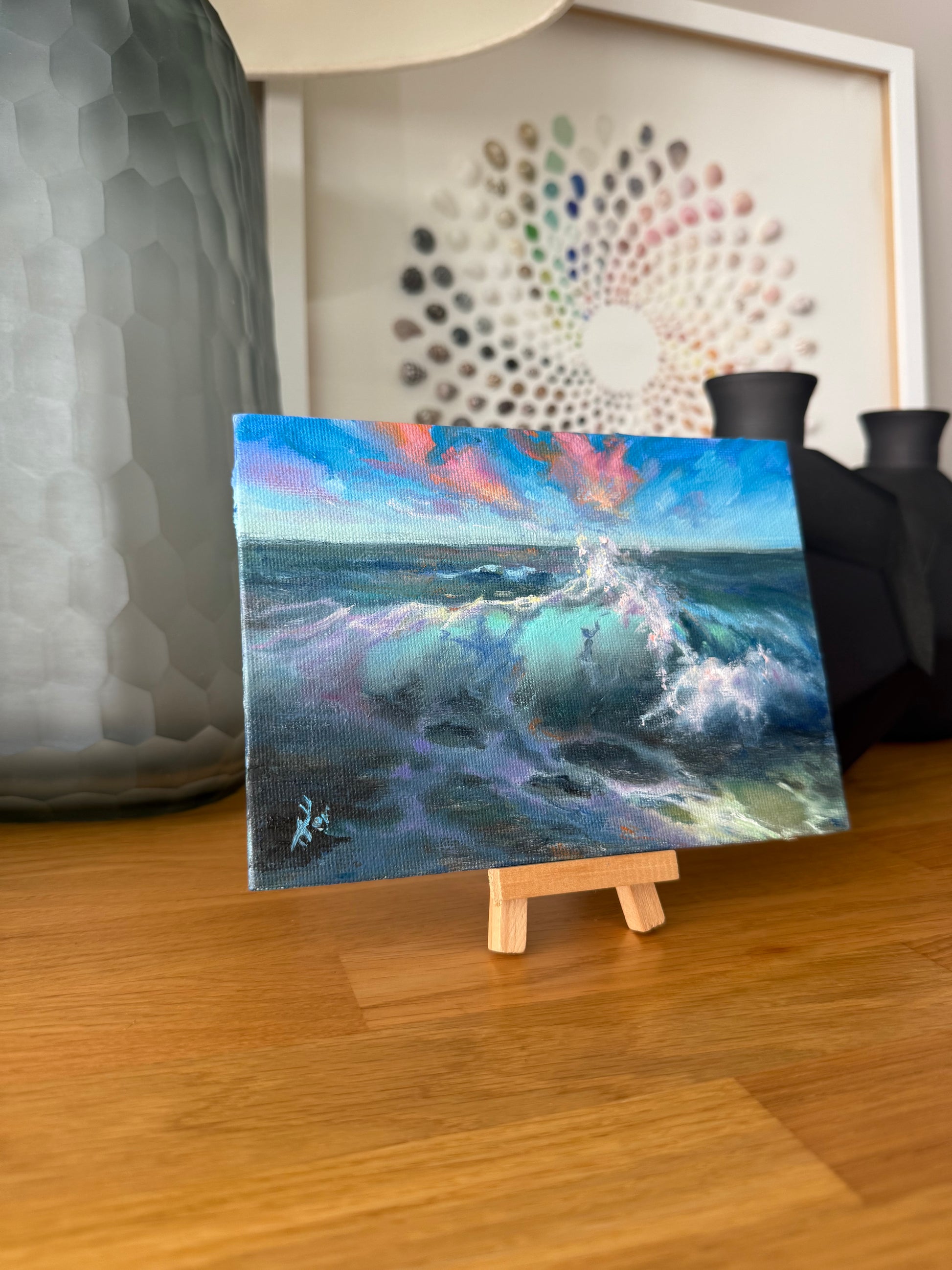 Small sea oil painting starting on a small wooden easel.