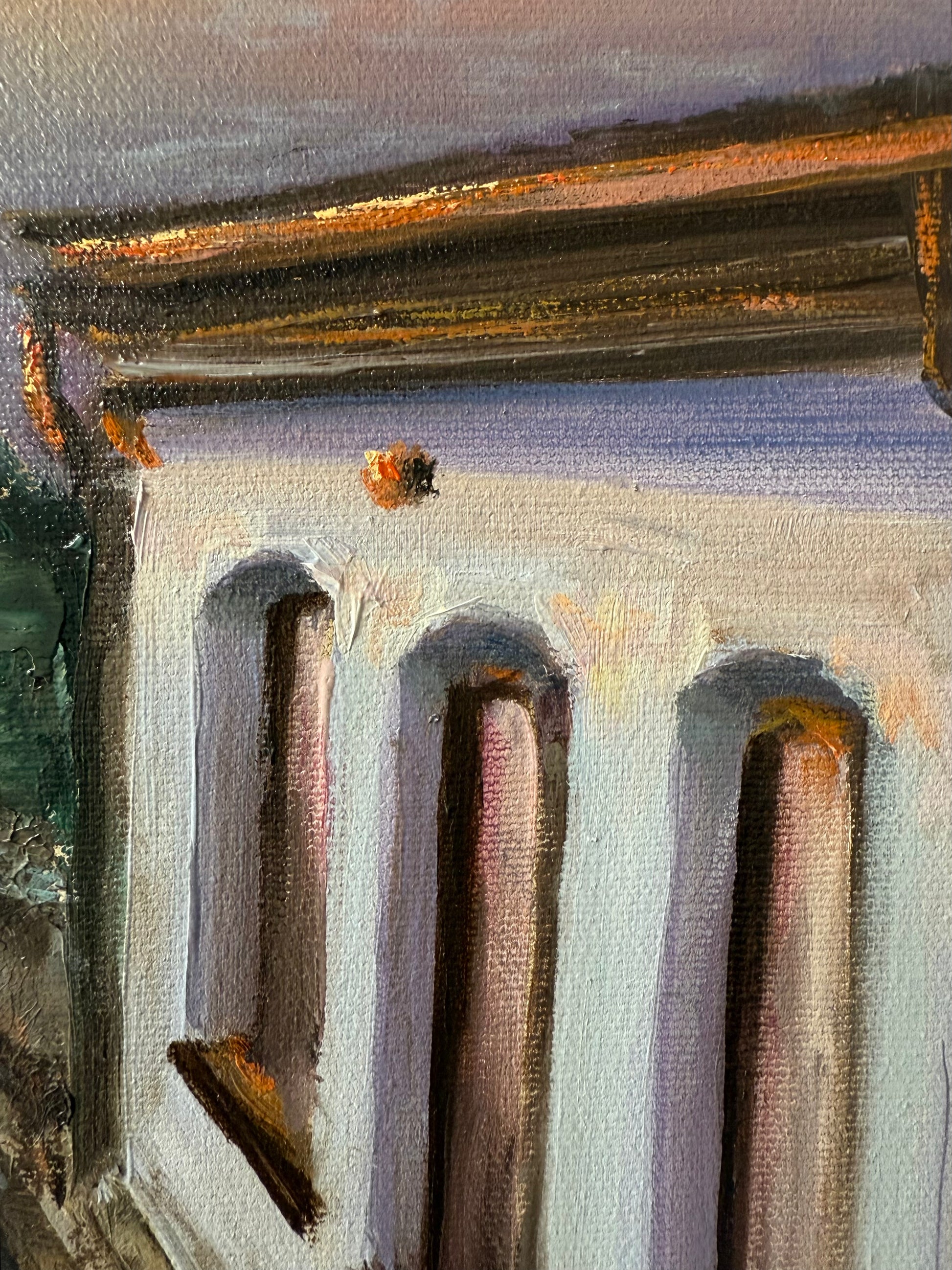 Close-up of a textured surface of an oil painting featuring beach cafe at sunset.
