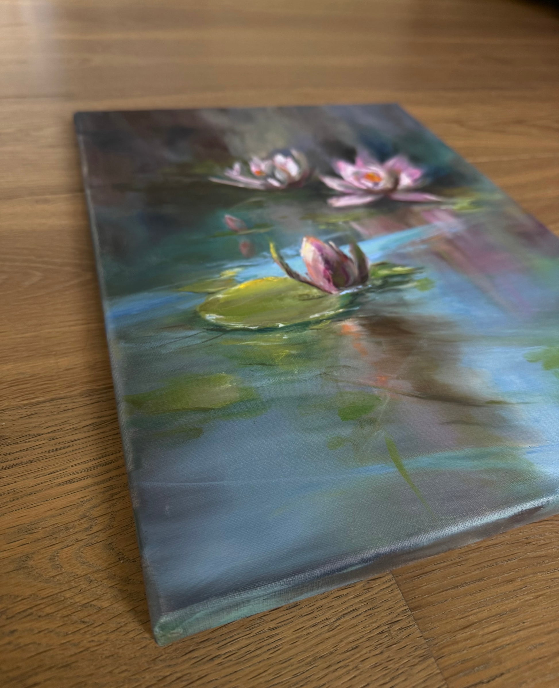 Painting of pink water lilies on a pond with reflections on water surface. Sides are painted. 