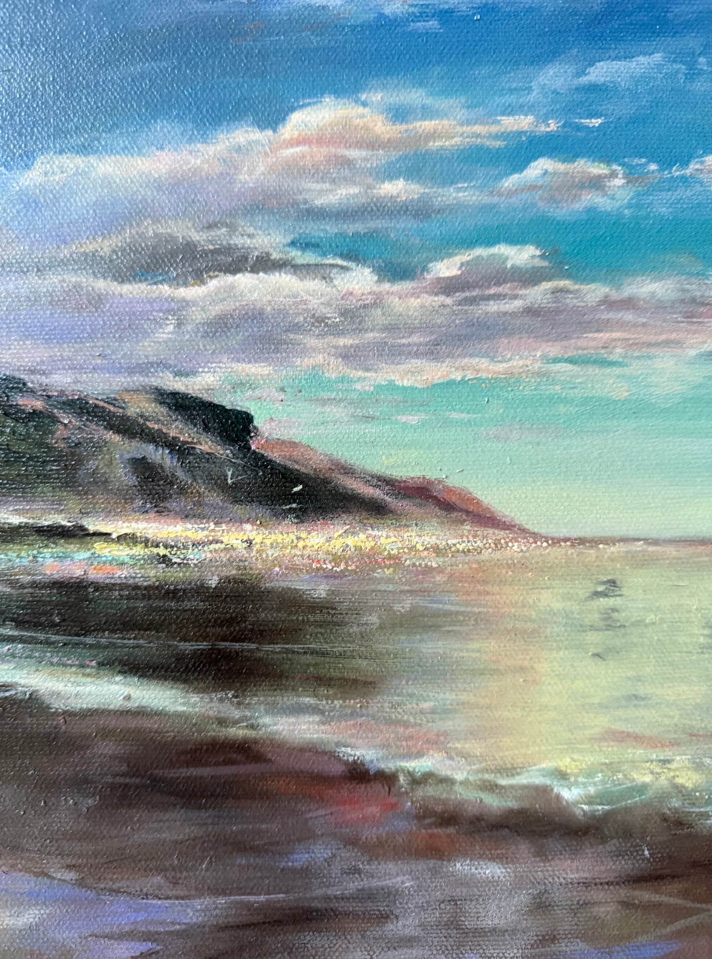 Close up of a Painting showing coastal scene with cliffs and a blue sky.