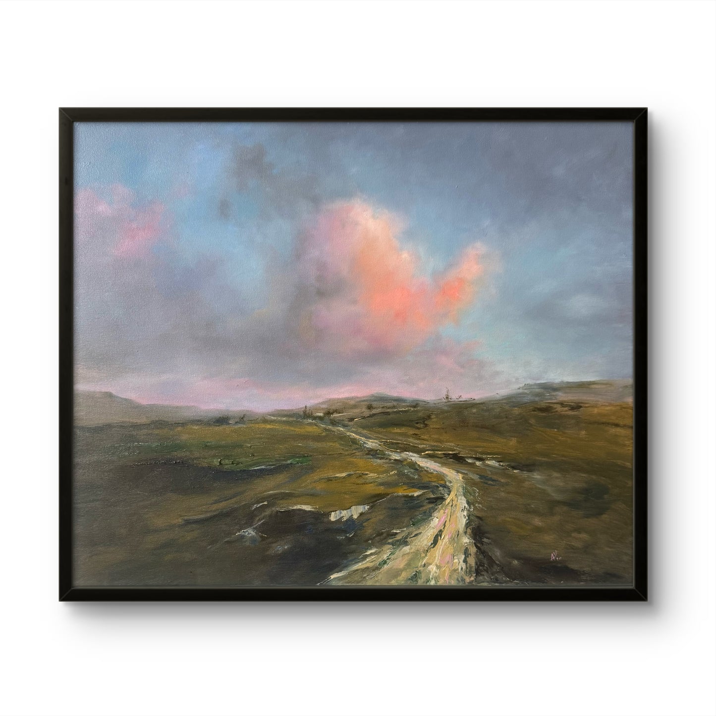 Framed painting of a landscape with a chalky path and colourful clouds in sunset sky.