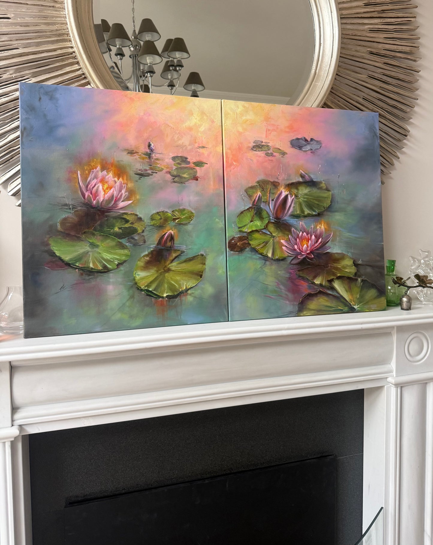 Two panels of water lily paintings on a fireplace mantle.