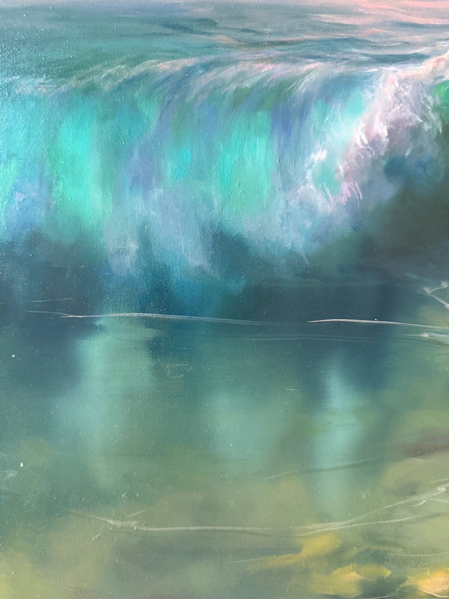 Close-up of a large wave with a gradient of blue and green colors.