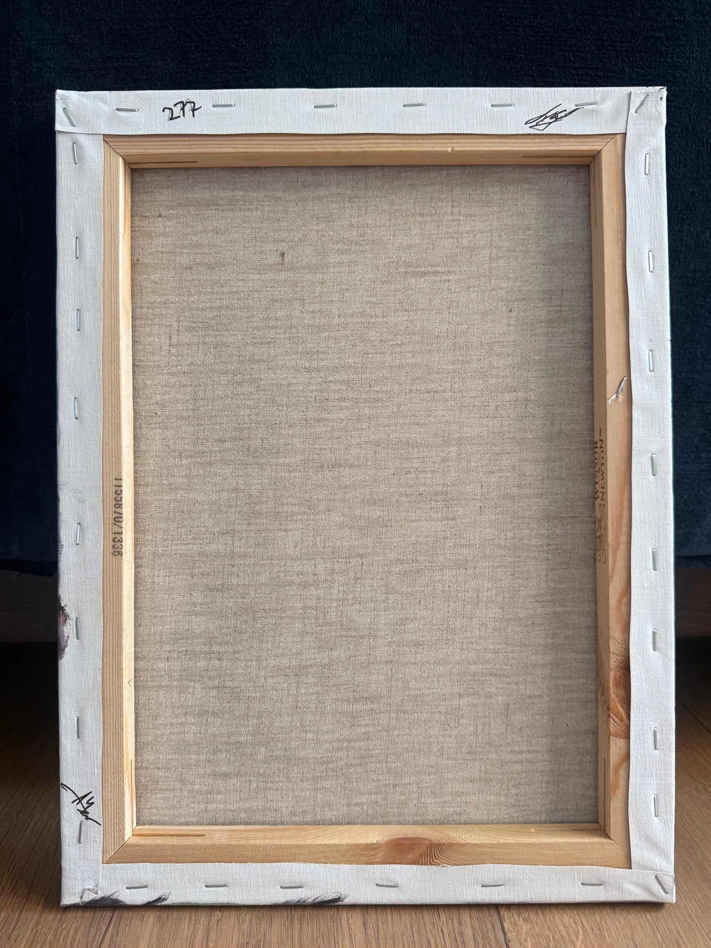 back of the painting showing beige linen stretched on wooden bars